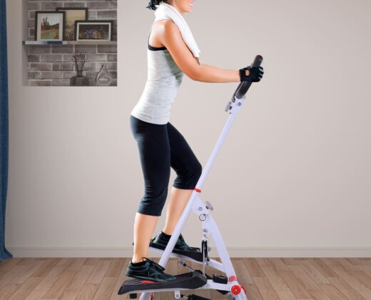 woman in a white top and black bottoms on a stepper machine