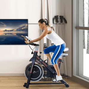 woman in a white tee shirt and blue bottoms on an exercise bike