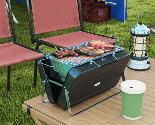 a portable barbecue grill on a camping table with two red camping chairs in the background, there are sausages and pork ribs on the barbecue