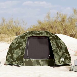 a 5 person fishing tent in a camouflage pattern, on a beach with sand dunes in the background